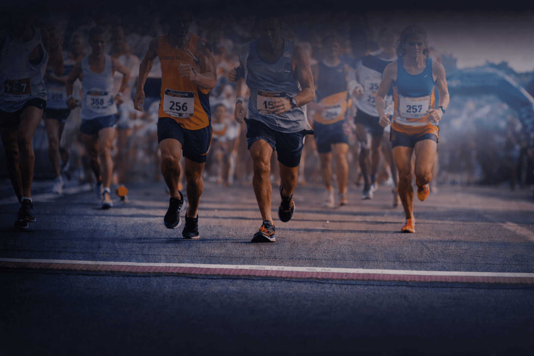 Runners racing down a city street